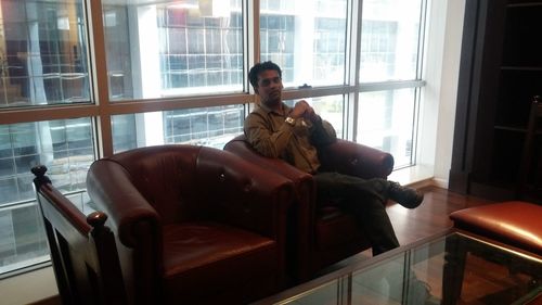 Portrait of man sitting in office