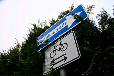 Low angle view of road sign against sky