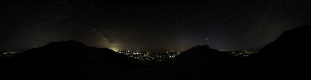Silhouette mountain against sky at night
