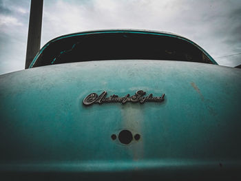 Low angle view of old rusty car against sky