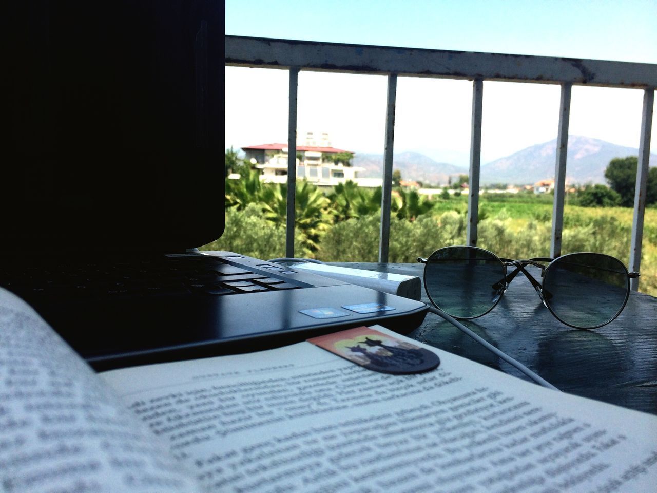 table, indoors, glass - material, window, focus on foreground, transparent, close-up, transportation, sky, selective focus, sunlight, day, mode of transport, chair, car, built structure, glass, land vehicle, no people, absence