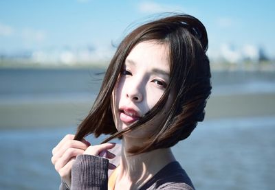 Portrait of young woman holding water