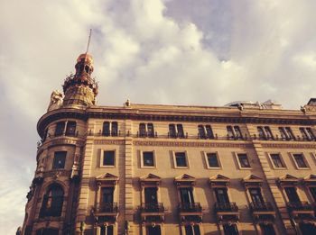 Low angle view of building against cloudy sky