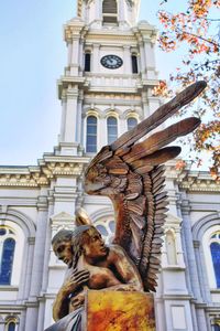 Low angle view of statue against building