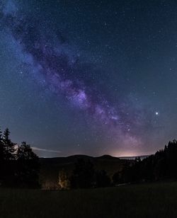 Scenic view of star field against sky at night