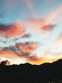 Low angle view of silhouette mountain against dramatic sky