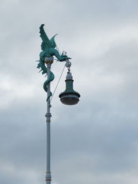 Low angle view of angel statue against cloudy sky