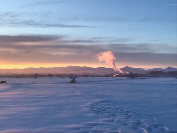 Scenic view of frozen lake against sky during sunset