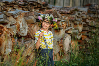 Portrait of woman standing by plants