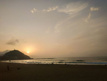 Scenic view of beach against sky during sunset