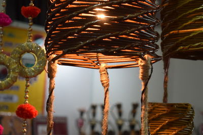 Close-up of wicker basket hanging from roof