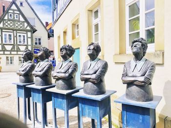 Statues sitting outside building