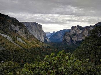 Scenic view of mountains against cloudy sky