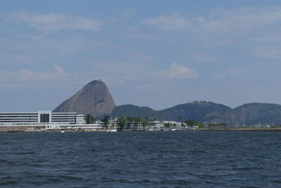 View of bay against cloudy sky