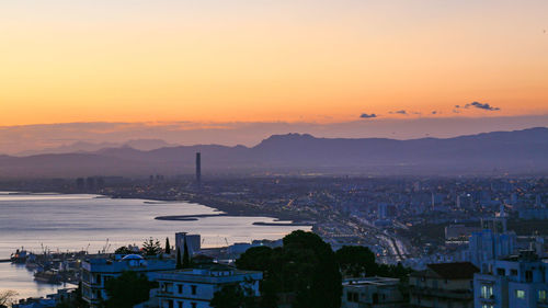 High angle view of buildings against sky during sunset