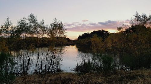 Scenic view of lake against sky at sunset