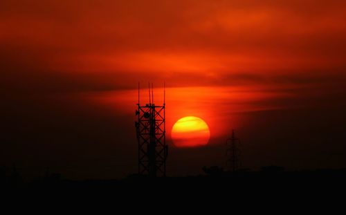 Silhouette tree against romantic sky at sunset