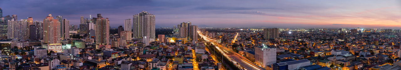 High angle view of illuminated modern buildings in city against sky