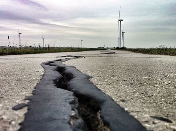 Surface level of road against cloudy sky