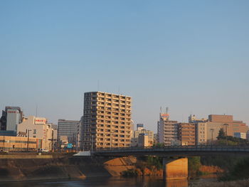 Buildings in city against clear sky