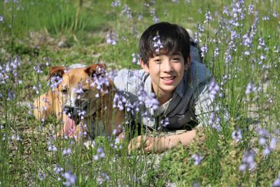 Portrait of smiling boy on grassy field