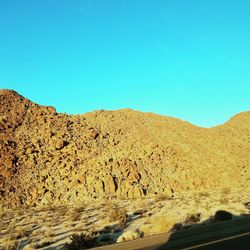 View of desert against clear blue sky