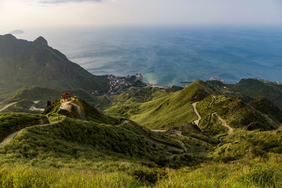 Scenic view of sea and mountains against sky