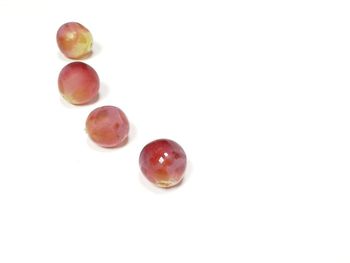 Close-up of fruits over white background