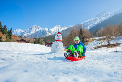 People skiing on snow covered mountain