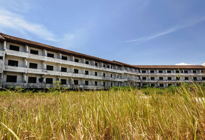 Built structure on field against sky