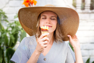 Midsection of woman holding ice cream