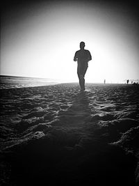 Full length of woman standing on beach