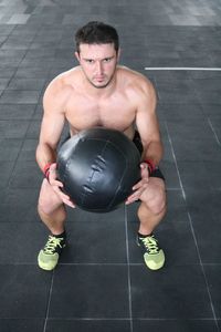 Shirtless muscular man exercising in gym