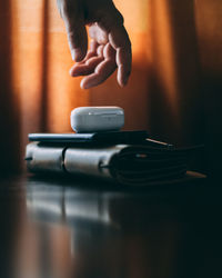 Close-up of person using mobile phone on table