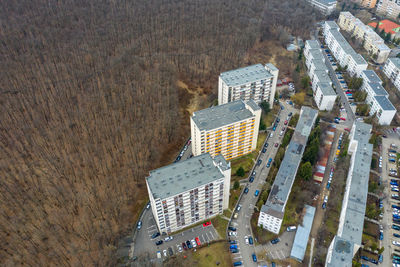 Aerial view of city expansion against nature. expanding flat of blocks occupy forest