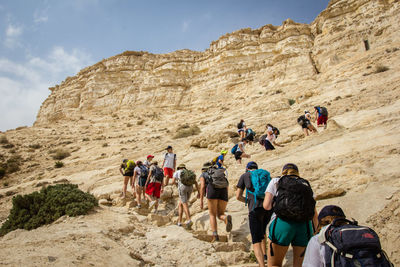 Low angle view of people walking in desert