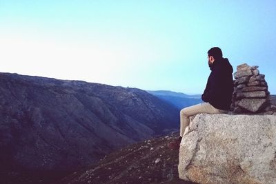 Man on landscape against clear sky