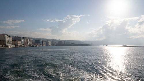 Panoramic view of sea and buildings against sky