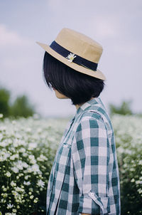 Rear view of woman standing against plants