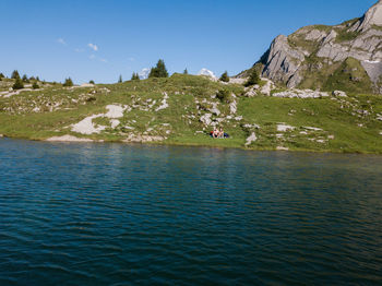 Couple sitting by lake