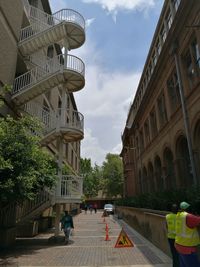 Man in city against sky