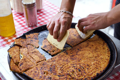 Cropped hand of person preparing food