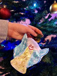Close-up of hand holding christmas tree