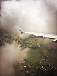 Cropped image of airplane flying over landscape