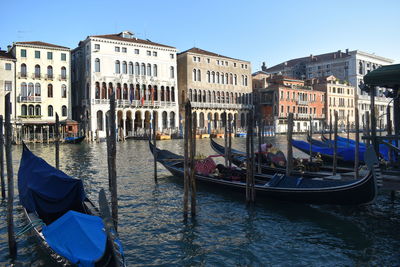 Gondolas docked on riverway and beautiful venice architecture.  