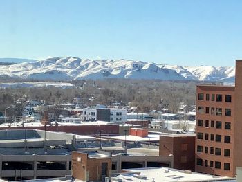 Aerial view of snowcapped mountains against clear sky