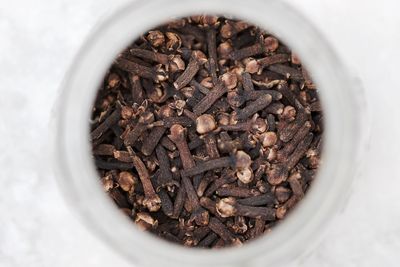 High angle view of dried cloves in container