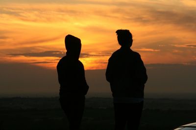 Silhouette of people at sunset