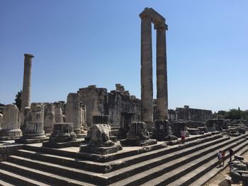 Old ruins in city against clear sky