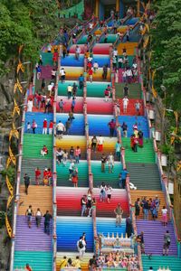 Color makes the climb more enjoyable- climbing up the rainbow colored stairs to temple at batu caves